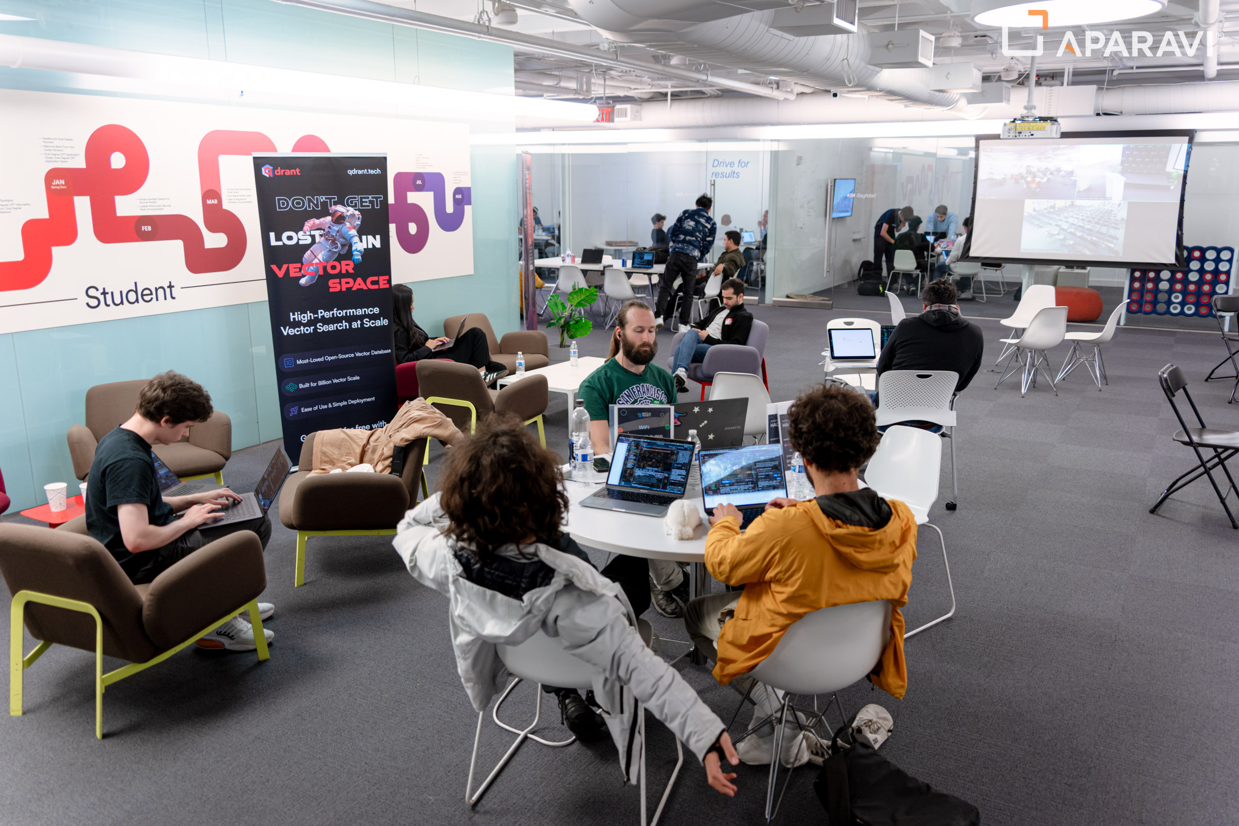 Studierende arbeiten beim Hult-KI-Hackathon an Laptops - Eventfoto mit Aparavi-Logo